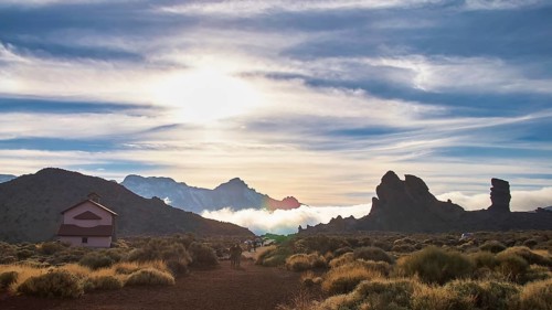 Ermita de las Nieves, vast landscape with a building, mountains and cloud cover in soft evening