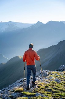 Hiker enjoying the mountain panorama in the morning, Venediger group, behind Dreiherrenkopf,
