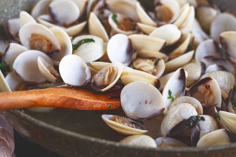 Cooking, vongole clams, in a pan with spices and white wine, top view, no people