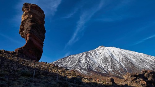 Roques de Garcia, dramatically shaped rock against snow-covered mountain, Teide, Parque Nacional