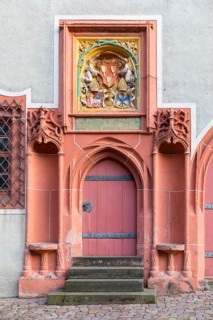 Historic pointed arch portal with seating niches and coat of arms at the cathedral provost's office