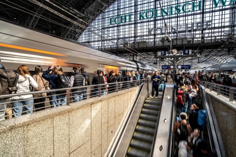 Cologne Central Station, escalators to and from the platform, passengers waiting for the train,