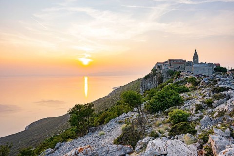 Small fishing village (Lubenice) built on the rocks high above the sea with a view of the sea on a