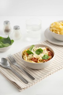 A bowl of spaghetti topped with rich tomato sauce, fresh spinach leaves, and grated cheese.