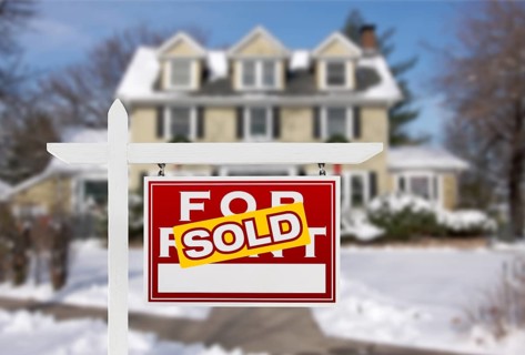 Sold Home For Sale Real Estate Sign in Front of New Snow Covered House