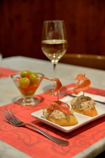 Russian salad with Iberico ham on white bread, green olives and white wine in a tapas bar, Palma,