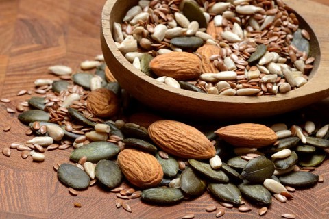 Kernels in ladle, kernel mix of almond kernels, sunflower seeds, linseeds and pumpkin seeds