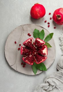 Fresh, cut pomegranate fruit, on a gray background, food concept, top view, no people