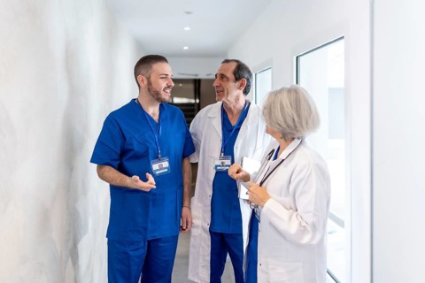 Professional medical team members in hospital scrubs and lab coats discussing healthcare matters