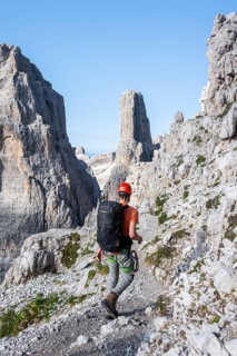 Climbers on a rock band, Bocchette Centrale band trail, via ferrata in the Brenta Mountains,