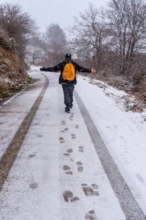 A young man enjoying himself on the snowy road of gipuzkoa's mount aizkorri. Snowy landscape by