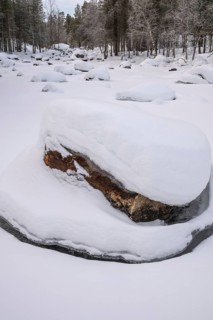 Frozen and snowy stream, Lapland, Finland, January 2025