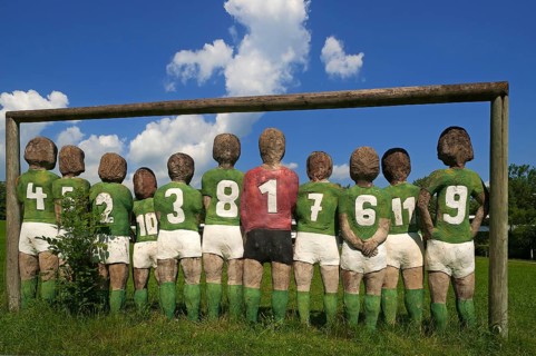 Sculptures of a football team, back view, by Günter Schumann, park of the Museum der Phantasie,