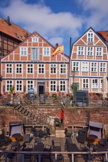 Historic half-timbered houses, stairs and a pontoon with a catering area on the waterfront West in