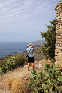 Man photographing the Mani coast from the fortified village of Vathia, Mani Peninsula, Laconia,