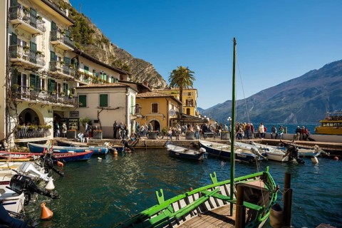 Picturesque village and colorful houses on the lake and steep mountains, Limone sul Garda, Lake