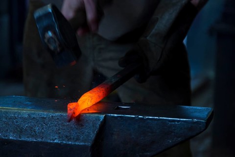 A blacksmith forging, working at the Ehnert forge in Dresden-Bühlau, Saxony, Germany
