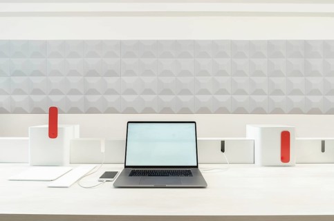 A sleek workspace in office featuring a laptop, smartphone, and tablet. The minimalist design is