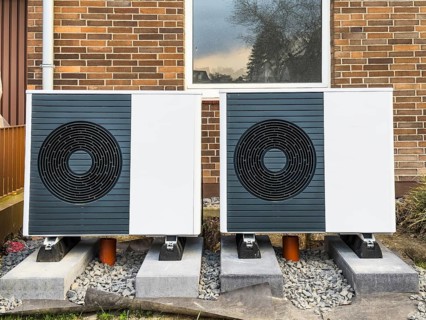 2 heat pumps are installed on an apartment block in a front garden, Hilden, Germany