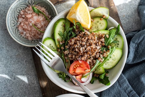 A nutritious lunch featuring fresh rocket, chopped oregano, cherry tomatoes, cucumber, Himalayan