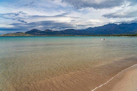The beach and mountains at Calvi Bay, Balagne, Corsica, France