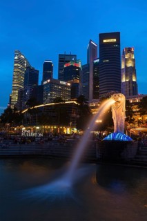 SINGAPORE, JANUARY 1, 2014: Night view of Singapore Merlion at Marina Bay against Singapore skyline