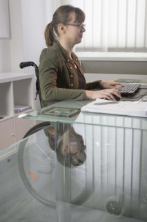 Young woman in a wheelchair at her workplace, Berlin, 18/01/2017