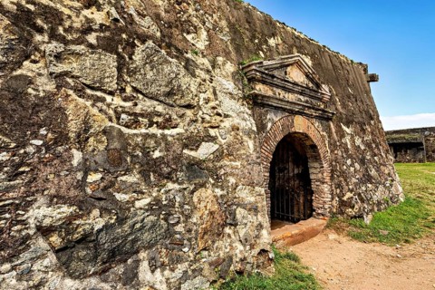 Detail of an old stone wall with archway in a fortress, The fortress of Galle in Sri Lanka