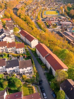 Rooftop view of a residential area with red roofs and trees in autumn, Nagold, district of Calw,