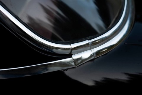 Front window with chrome strips, detail, classic car, black Volvo Amazon, medium class car from