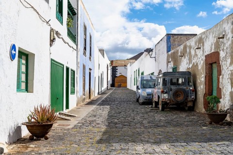 Typical white houses with colored doors and windows in an alley, Teguise, Lanzarote, Canary