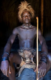 Young Himba man in his hut, Ohandungu, Kunene region, Kaokoveld, Namibia