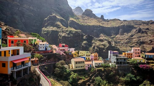 Panoramic view, small settlement, colorful village, picturesque nestled in raw, dramatic mountains