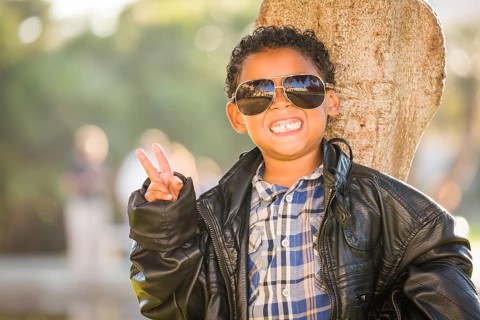 African American and Mexican Boy Dressed Up with Sunglasses and Leather Jacket