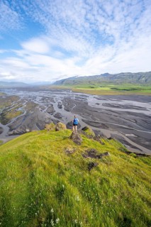 Hiker, Young woman on a hill, view over alluvial land, meandering river, Dímonarhellir, Suðurland,
