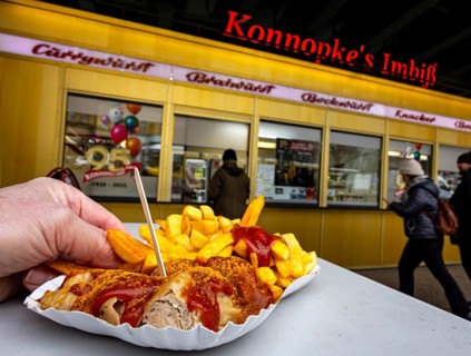 Cult in Berlin: Currywurst at Konnopke's Imbiss. Sausage with ketchup and french fries. Behind it,