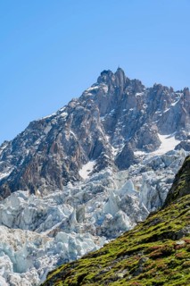 Glacier ice of the Glacier des Bossons, behind pointed mountain peaks, Chamonix, Haute-Savoie,