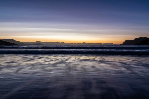 Ocean surf in sandy bay on the Norwegian European Sea at dusk, Söröya, Finnmark, December 2018