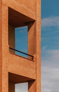 Minimalist architectural detail showcasing a modern structure with a textured facade against a