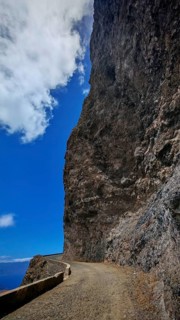 Narrow road along a high rock face under clear blue sky, hiking, Monte Verde, Sao Vicente, Cabo