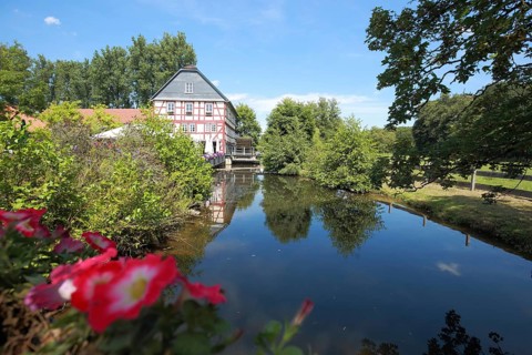 Walkemühle with reflection in the Eder, half-timbered house, Frankenberg, Hesse, Germany