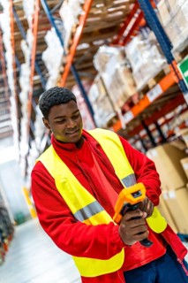 Latin male warehouse worker using barcode reader to scanning a barcode on order picking to confirm