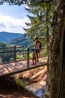 Mother with her son on a bridge at the Todtnau waterfall in the Black Forest in Germany