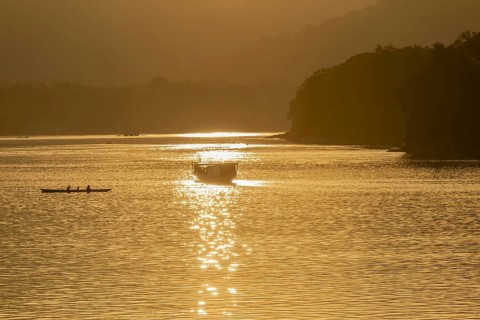 Sunset on the Mekong with excursion boats, near Luang Prabang, Laos