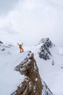 Ski tourer on a summit, Snowy mountain landscape, Bernese Alps, Bernese Oberland, Switzerland