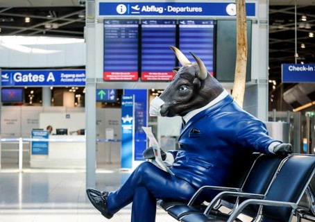Bull figure with face mask in deserted departure hall at Düsseldorf Airport in times of the corona