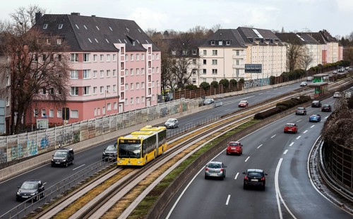 Essen, North Rhine-Westphalia, Germany - Cars and a public bus drive through Essen city centre on