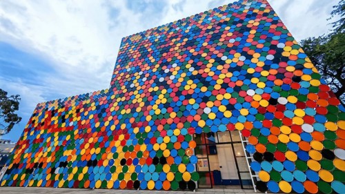 Colourful façade of circular panels in vivid colors and geometric patterns, Mindelo Cultural