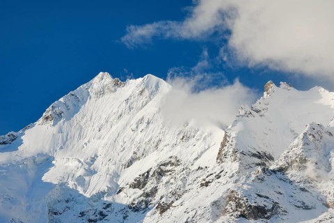 Freshly snow-covered summit of Piz Bernina and Biancograt, Engadin in the canton of Graubünden,