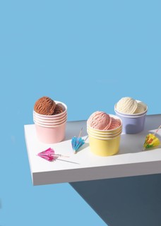 A vibrant shot of chocolate, strawberry, and vanilla ice cream cups with decorations. Soft and airy